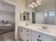 Clean bathroom with double sinks and a view of a bedroom at 10558 Lieter Pl, Lone Tree, CO 80124