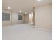Open finished basement with neutral carpet, base trim, and windows for natural light at 1907 S Columbine St, Denver, CO 80210