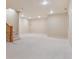 A view of the finished basement, highlighting the neutral carpet and staircase to the upper level at 1907 S Columbine St, Denver, CO 80210