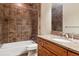 Bathroom featuring tile shower, granite counter vanity, and modern fixtures at 1907 S Columbine St, Denver, CO 80210