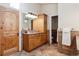 Bathroom with a wood vanity, granite countertops, and tiled floors, with adjacent toilet and shower area at 1907 S Columbine St, Denver, CO 80210