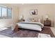 Bright bedroom featuring a patterned rug, bedside tables and lamps, with a horse art piece above the bed at 1907 S Columbine St, Denver, CO 80210