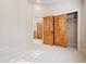 Bedroom with wood trim doors and walk-in closet with bright natural light from a window at 1907 S Columbine St, Denver, CO 80210