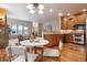 Cozy dining area adjacent to the kitchen and living room, featuring hardwood floors and natural wood cabinetry at 1907 S Columbine St, Denver, CO 80210