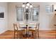 Cozy dining area features a round table, seating for four, and a large window with natural light at 1907 S Columbine St, Denver, CO 80210