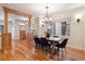 Open dining area featuring wood floors and trim, offering a view into adjacent rooms and plenty of natural light at 1907 S Columbine St, Denver, CO 80210