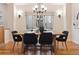 Well-lit dining area with modern chandelier, large window, and classic hardwood floors, providing a welcoming atmosphere at 1907 S Columbine St, Denver, CO 80210