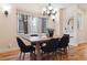 Elegant dining room with natural light, stylish chandelier, and hardwood floors, ideal for Gathering gatherings at 1907 S Columbine St, Denver, CO 80210