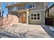 Charming two-story home with green shingle siding, brick accents, and a wooden front door at 1907 S Columbine St, Denver, CO 80210