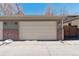Two car garage with neutral siding and brick accents at 1907 S Columbine St, Denver, CO 80210