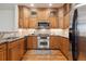 A spacious kitchen boasting stainless steel appliances, granite countertops, and ample wooden cabinet storage at 1907 S Columbine St, Denver, CO 80210