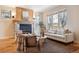 Comfortable living room with a stone fireplace, large window, and a cozy seating arrangement at 1907 S Columbine St, Denver, CO 80210