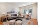 Bright living room with large window, neutral decor, and stylish furnishings, creating a comfortable and inviting space at 1907 S Columbine St, Denver, CO 80210