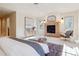 Spacious main bedroom with a fireplace, built-in storage and a view from two large windows at 1907 S Columbine St, Denver, CO 80210