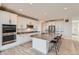 Modern kitchen features white cabinets, granite countertops, and stainless steel appliances at 3643 White Rose Loop, Castle Rock, CO 80108