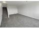 Carpeted basement area with stairs leading to another level at 8199 Welby Rd # 1908, Denver, CO 80229