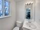 Bathroom with a simple vanity, toilet, and natural light at 8199 Welby Rd # 1908, Denver, CO 80229