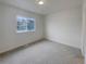 Bright, airy bedroom features a large window and neutral carpeting at 8199 Welby Rd # 1908, Denver, CO 80229