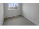 Neutral bedroom featuring carpeted floors, window with view, and white walls at 8199 Welby Rd # 1908, Denver, CO 80229