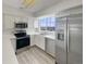 Modern kitchen featuring stainless steel appliances, white cabinets, and ample counter space at 8199 Welby Rd # 1908, Denver, CO 80229