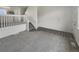 Spacious living room with neutral carpeting and laminate, featuring stairs at 8199 Welby Rd # 1908, Denver, CO 80229