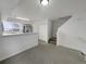 Open living room with breakfast bar, stairs, and ample lighting at 8199 Welby Rd # 1908, Denver, CO 80229