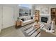 Bright living room featuring a fireplace, large windows, and modern furnishings at 8199 Welby Rd # 1908, Denver, CO 80229