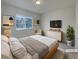 Cozy bedroom with a large window, a soft bed, and stylish decor at 8199 Welby Rd # 1908, Denver, CO 80229