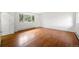 Spacious bedroom with hardwood floors, a large window, and baseboard heating at 133 Mine Ln, Boulder, CO 80302