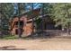 Rustic two-story home with a finished walkout basement, multiple decks, and a three-car garage nestled amongst the pines at 133 Mine Ln, Boulder, CO 80302