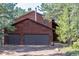 Exterior view of the home showcasing the spacious three-car garage, perfect for vehicle storage and hobbies at 133 Mine Ln, Boulder, CO 80302