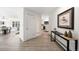 Hallway with light wood floors, white walls, and a view into the living and kitchen areas at 133 Mine Ln, Boulder, CO 80302