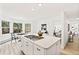 Bright and airy kitchen with a large island and views into the dining and living areas at 133 Mine Ln, Boulder, CO 80302