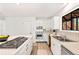 Open kitchen with stainless steel range, island cooktop, and plenty of natural light at 133 Mine Ln, Boulder, CO 80302