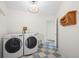 A functional laundry room with a washer, dryer, and utility sink, designed for convenience and efficiency at 133 Mine Ln, Boulder, CO 80302