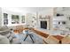 Bright living room featuring a fireplace, built-in shelving, and hardwood floors at 133 Mine Ln, Boulder, CO 80302