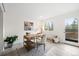 Bright home office with a modern desk, artwork, and natural light streaming through a large window at 133 Mine Ln, Boulder, CO 80302