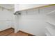 This walk-in closet offers plenty of storage with bright walls, wood floors, and custom shelving at 133 Mine Ln, Boulder, CO 80302