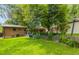 Enjoy the lush landscaping, mature trees, and an expansive lawn in the backyard at 2876 S Wolff St, Denver, CO 80236