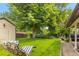 Lush backyard with a mature shade tree, providing a serene and private outdoor space with green grass at 2876 S Wolff St, Denver, CO 80236