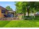Step into a backyard oasis with an outdoor grill, and lush landscaping at 2876 S Wolff St, Denver, CO 80236