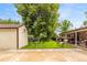 Spacious backyard with a shed, lush green grass, and a patio area, ideal for outdoor activities and relaxation at 2876 S Wolff St, Denver, CO 80236