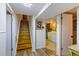 Basement with wood stairs, white paneling, and laundry room access at 2876 S Wolff St, Denver, CO 80236