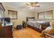 Cozy bedroom with hardwood floors, ceiling fan, and natural light at 2876 S Wolff St, Denver, CO 80236