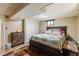 This bedroom boasts wood-look floors, a queen bed and custom furnishings at 2876 S Wolff St, Denver, CO 80236