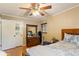 Bedroom with a ceiling fan, hardwood floors, dresser, and natural light at 2876 S Wolff St, Denver, CO 80236