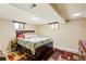 This bedroom boasts wood-look floors, a queen bed and a colorful area rug at 2876 S Wolff St, Denver, CO 80236