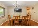 Chandelier above the dining table with seating for four people and view to adjacent spaces at 2876 S Wolff St, Denver, CO 80236