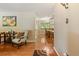 Inviting entryway featuring gleaming hardwood floors leading to a dining area with a chandelier at 2876 S Wolff St, Denver, CO 80236
