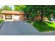 Brick home with covered front porch, attached garage, and manicured lawn at 2876 S Wolff St, Denver, CO 80236